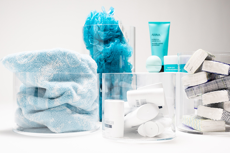 Plastic cylinder containers holding toiletry products.