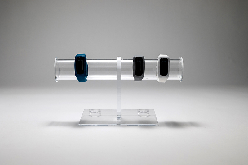 Plastic retail display stand displaying watches.