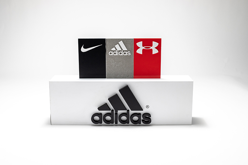 Acrylic signage with Nike, Adidas and Under Armor logos.